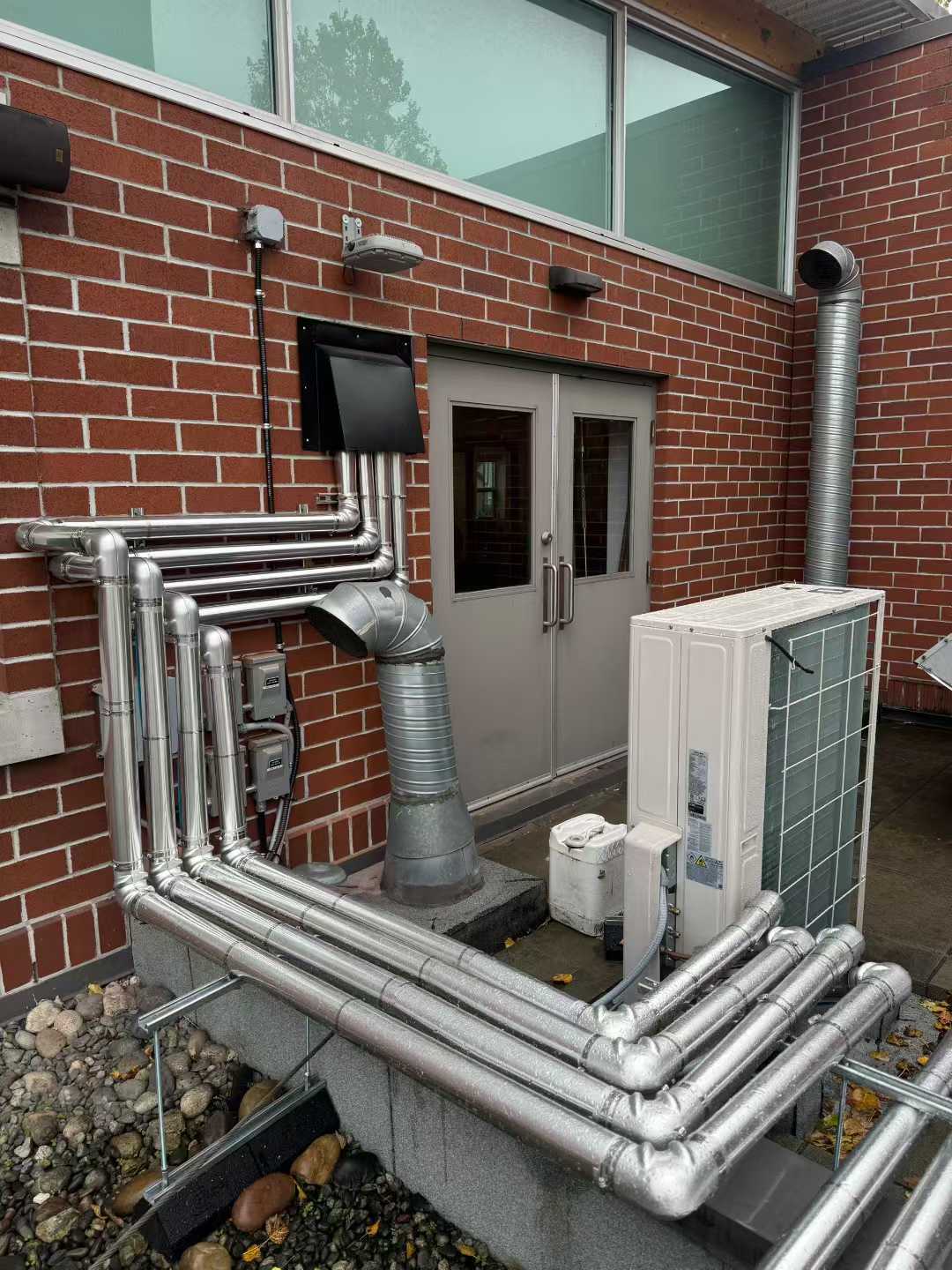 Insulated piping and outdoor equipment at Richmond Hamilton Fire Hall